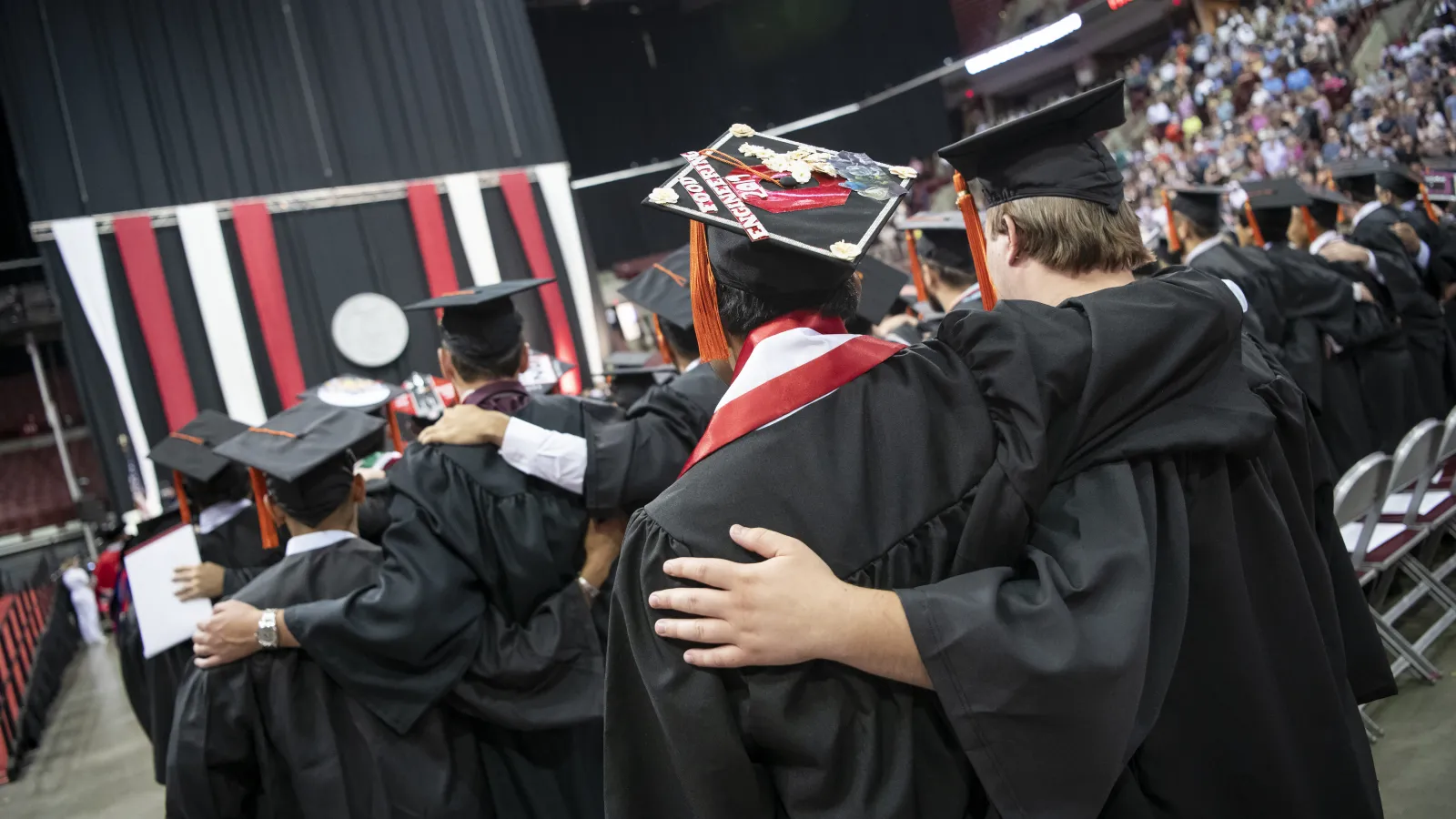 graduates at schottenstein center singing Carmen Ohio