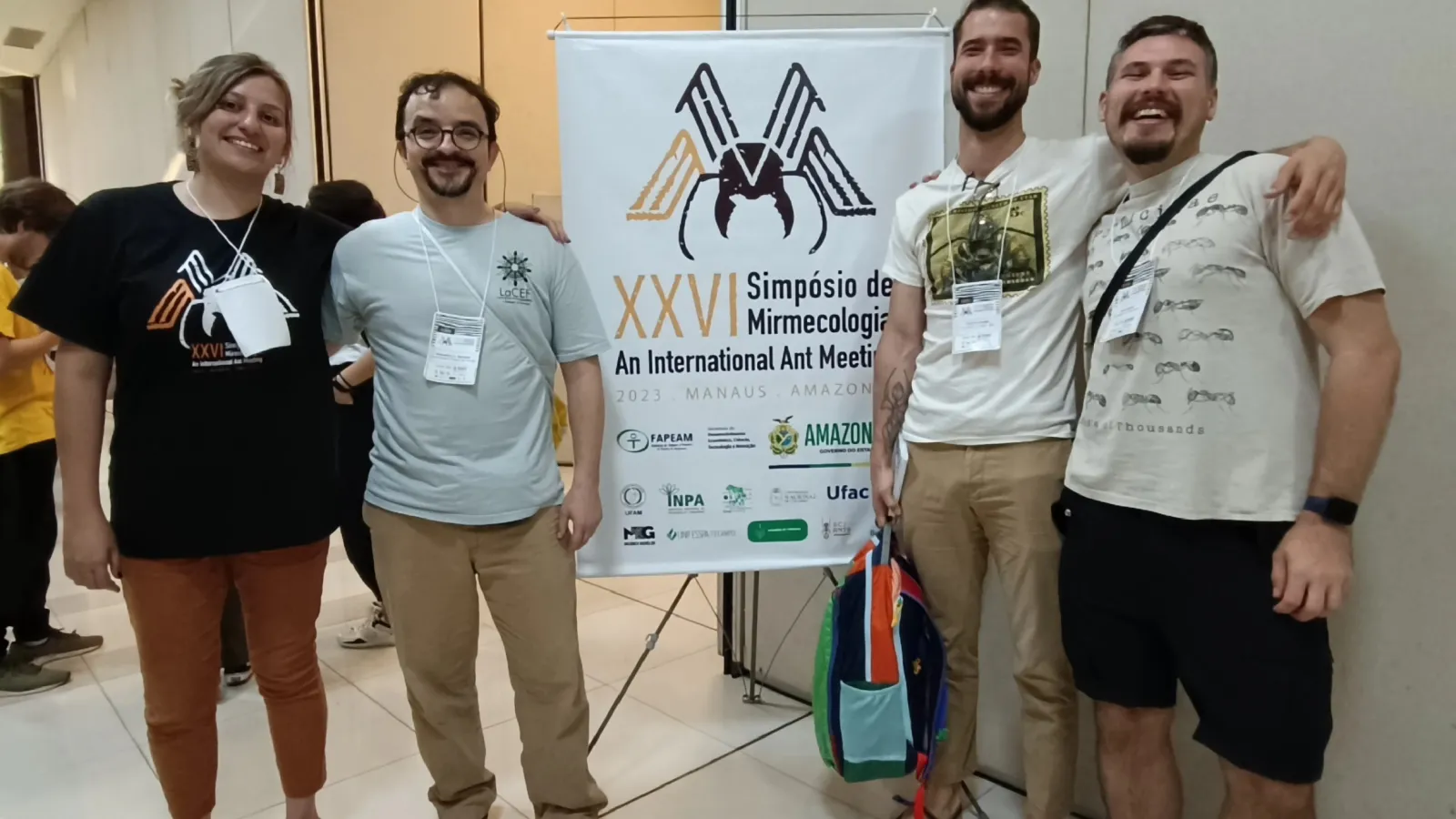 researchers in front of sign near meeting room