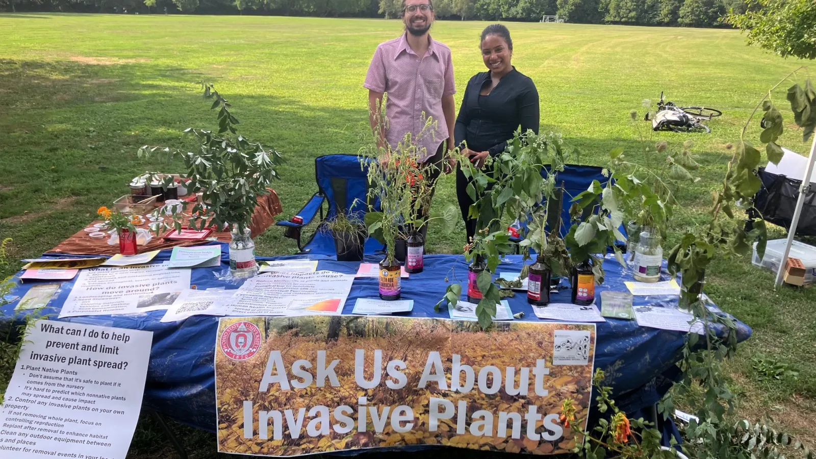 invasive plants on display table with Jaros standing behind