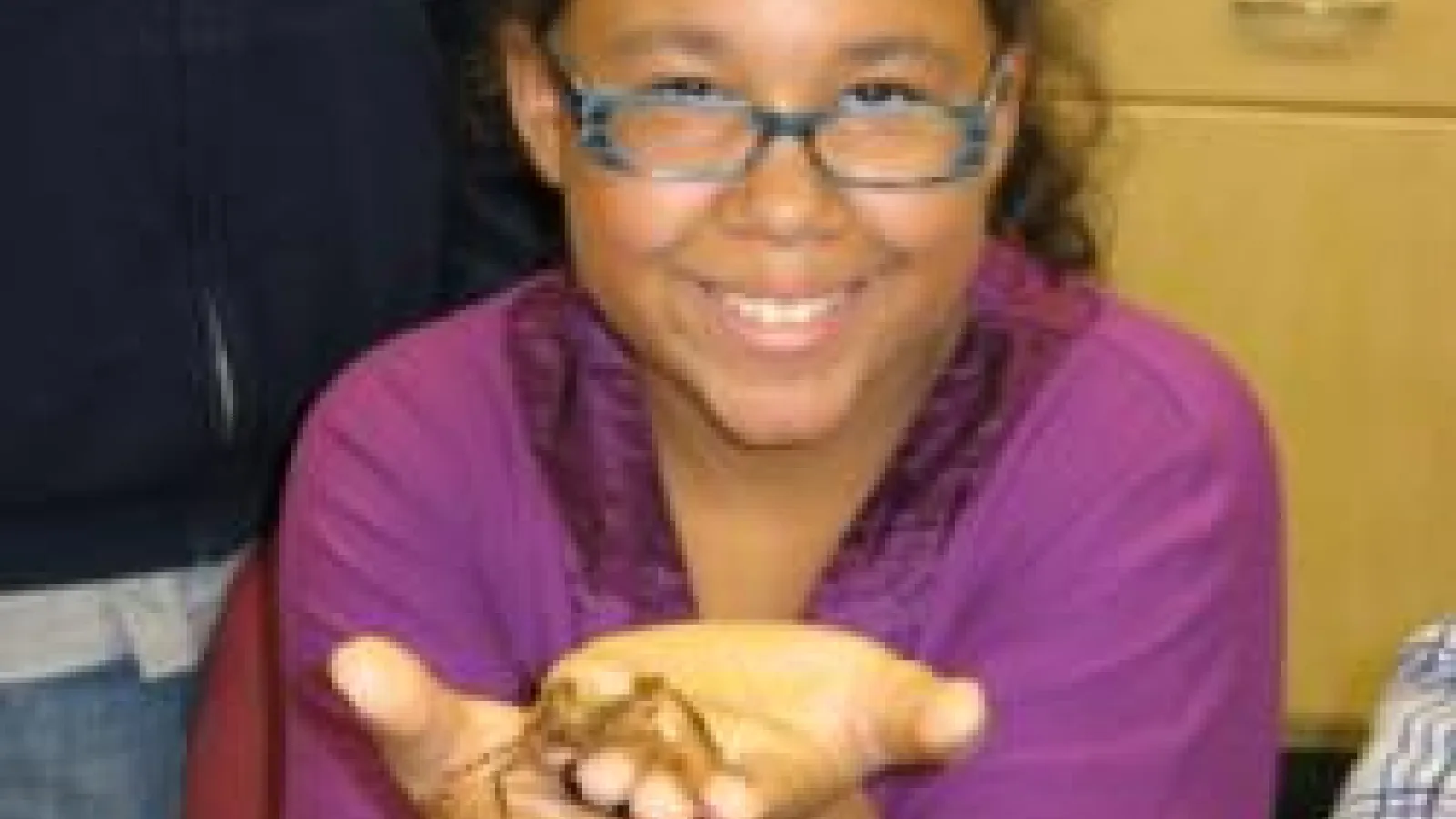 Student holding arthropod in hands