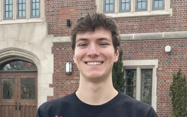 head and shoulders shot of Connor Ferguson standing in front of building