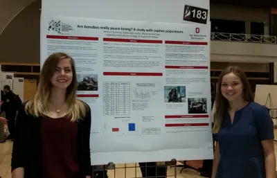 Maddie Zimmerly&nbsp;and&nbsp;Sophie Aller in front of research poster at Denman