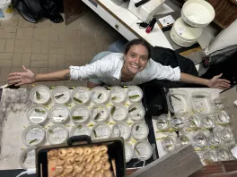 Birds Eye view of Isabel Pen standing over a table filled with anemones in containers
